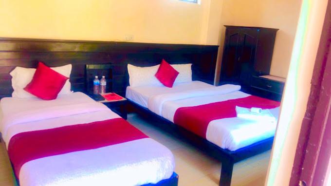Katil atau katil-katil dalam bilik di Hotel Sarathi