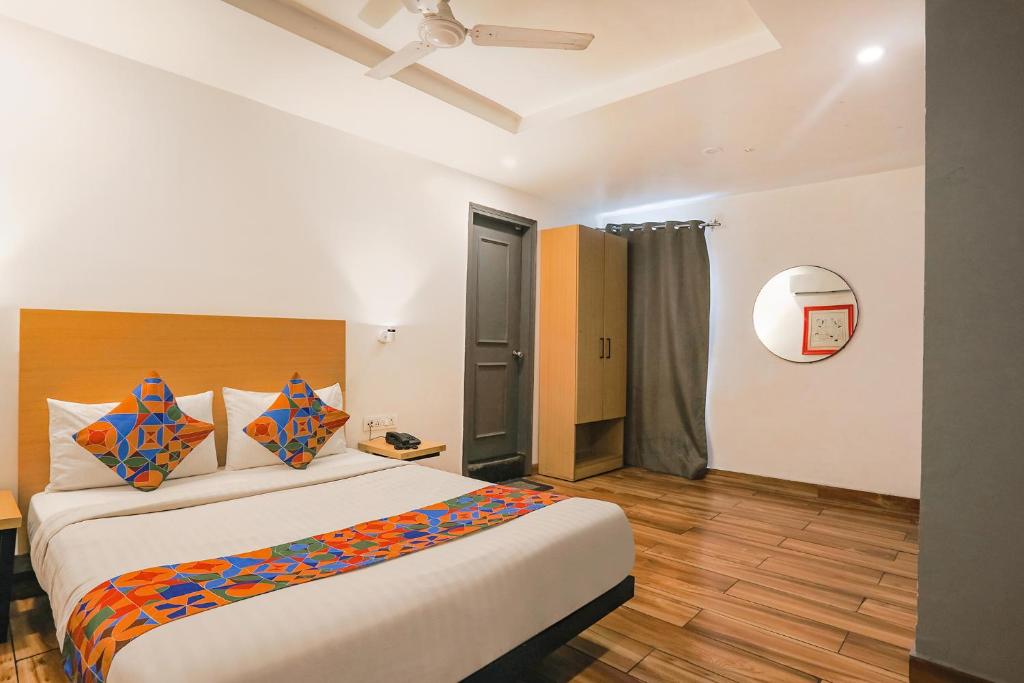 a bedroom with a large bed in a room at FabExpress PP Residency in New Delhi