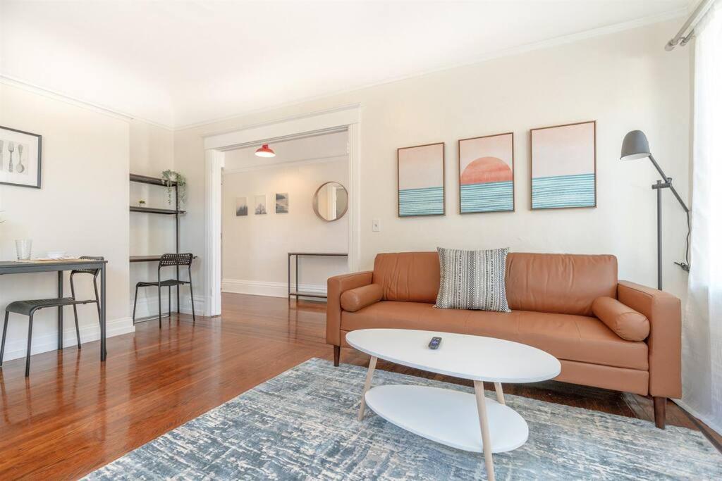 a living room with a couch and a table at Modern Apt near all conveniences in Oakland