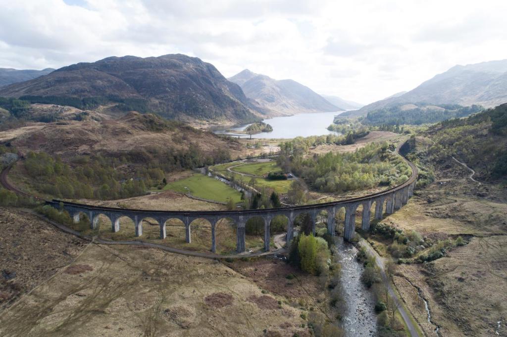 a bridge over a river in the mountains at The Morar Hotel in Morar