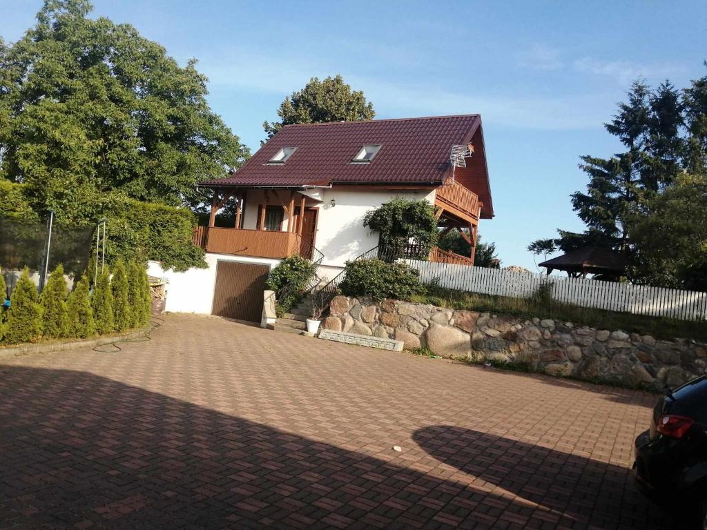 a house with a brick driveway in front of it at DOMEK SASINO in Sasino