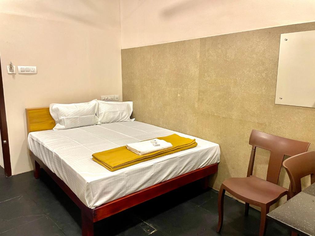 Postel nebo postele na pokoji v ubytování Reach Residency