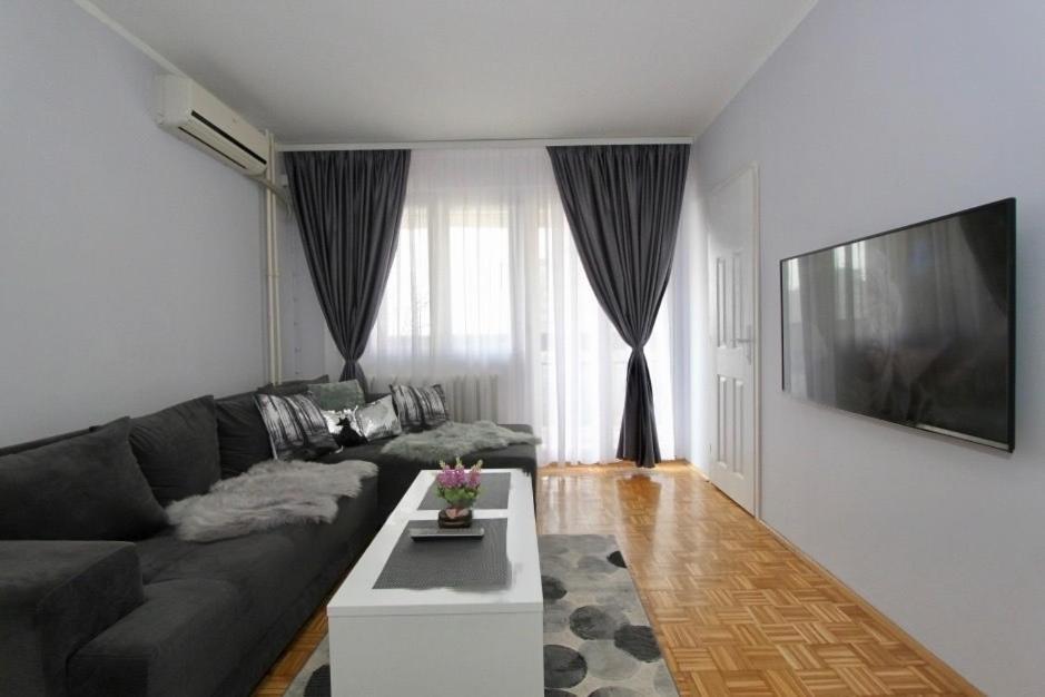 a living room with a couch and a table at Cezar Apartment in Belgrade