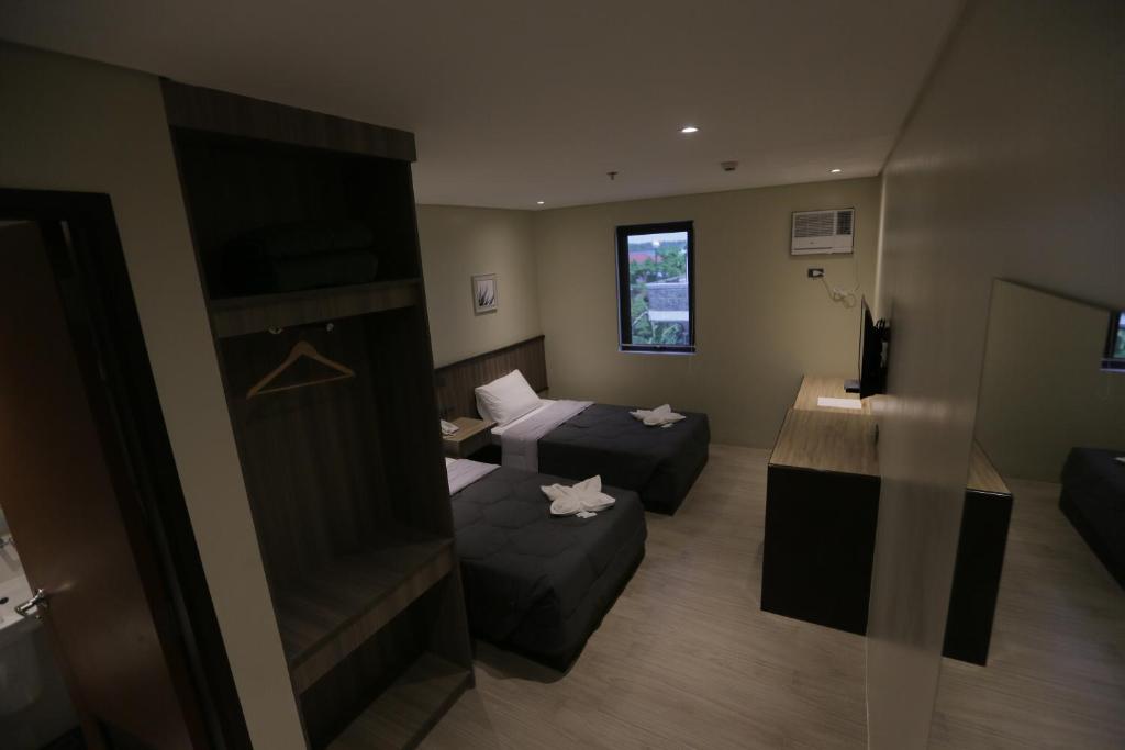 Postel nebo postele na pokoji v ubytování PILAR MARINA INN