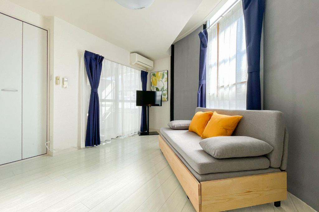 a living room with a couch and a window at Osaka house honkan なんば-心斎橋エリア in Osaka