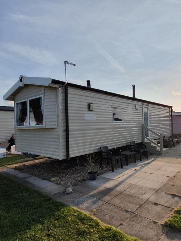 a small house with a roof on a patio at Fantasy Island King Fisher 8Berth 402 in Ingoldmells