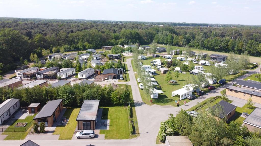 an aerial view of a small village with a parking lot at Vakantiepark Camping de Peelpoort in Heusden