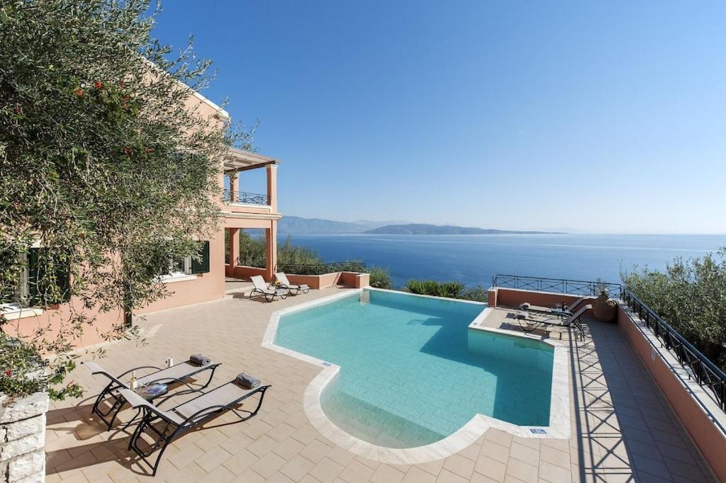 a swimming pool with a view of the ocean at Villa Kyma, Kaminaki Villas in Corfu With Private Pool And Spectacular Sea Views in Agní