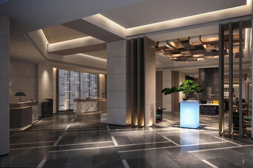 a lobby of a building with a potted plant at Delta Hotels by Marriott Xi'an in Xi'an
