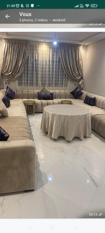 a living room with two beds and a couch at Appartement neuf in Nador