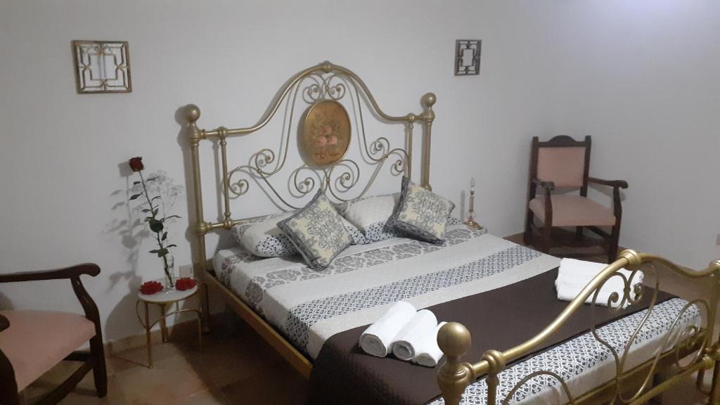 een slaapkamer met een bed en een stoel bij Sicilia bedda in Palermo