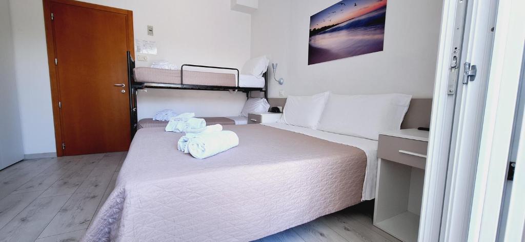 Postel nebo postele na pokoji v ubytování Hotel Sasselli