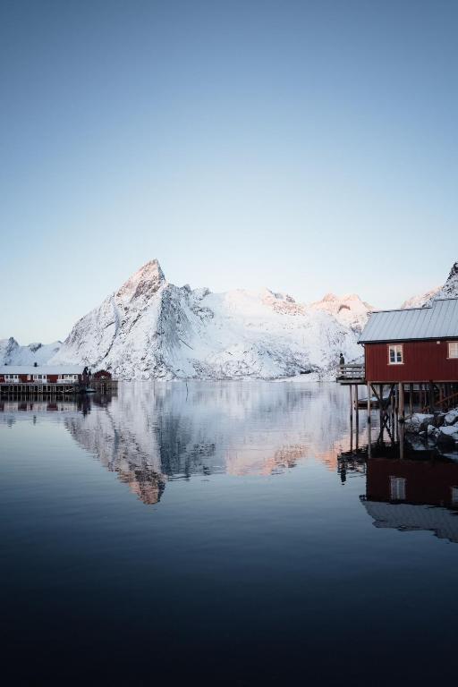a house on a dock on a body of water at Reinefjorden Sjøhus in Reine