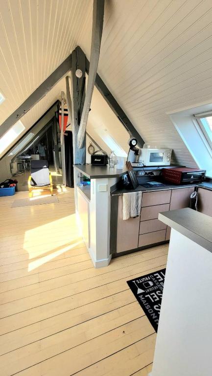 a kitchen with an island in a tiny house at Studio Design Sous Toits IntraMuros Vue Cathédrale in Vannes