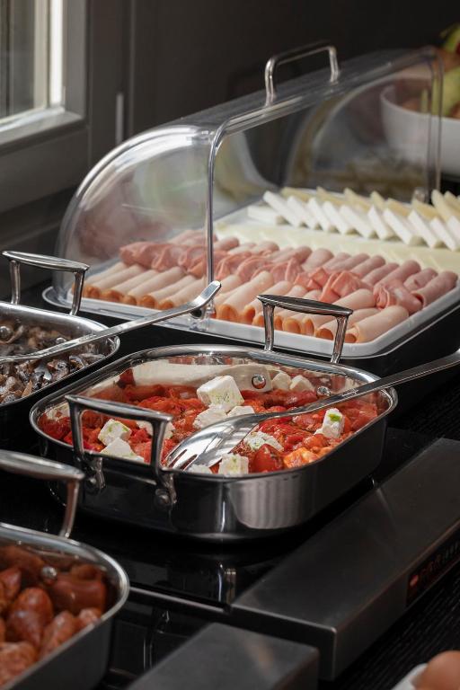a buffet with many trays of food on at ANEMI Folegandros in Karavostasi