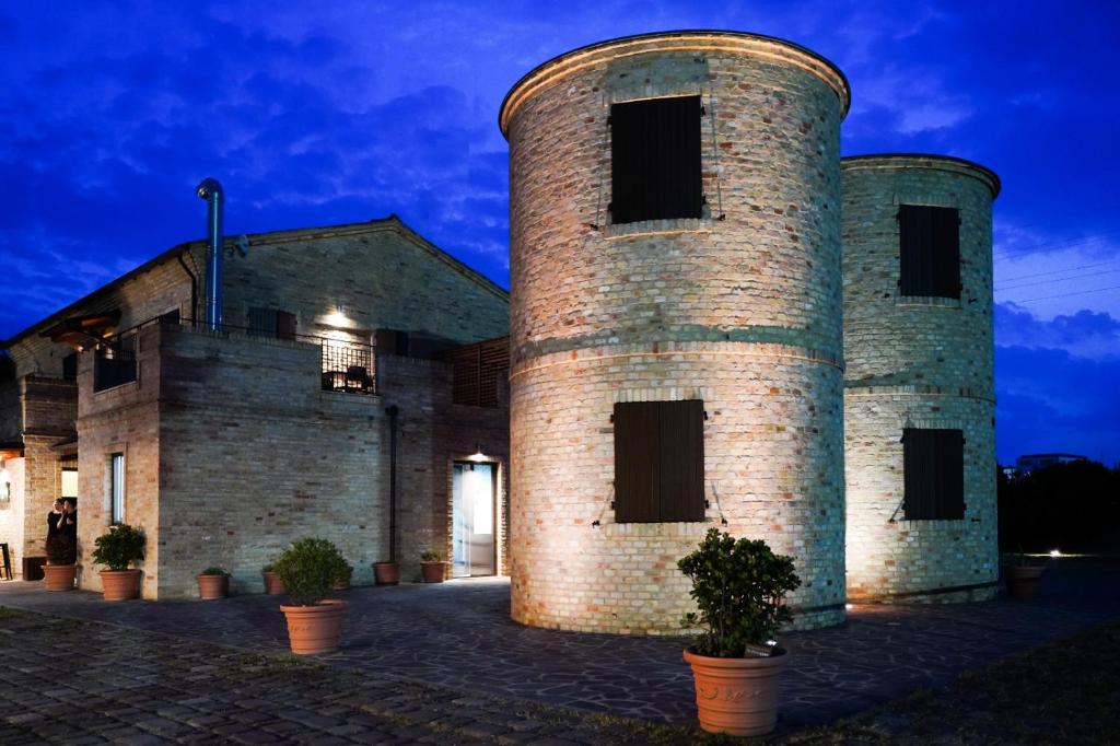 a large brick building with two towers at Moretti Village - SOPHIE ROOMS COUNTRY HOUSE in Civitanova Marche