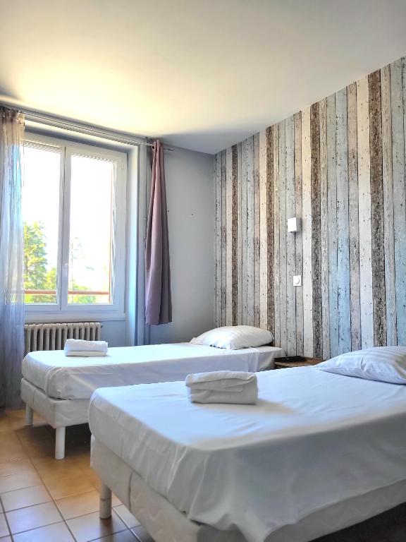 Postel nebo postele na pokoji v ubytování Cit'Hôtel La Résidence