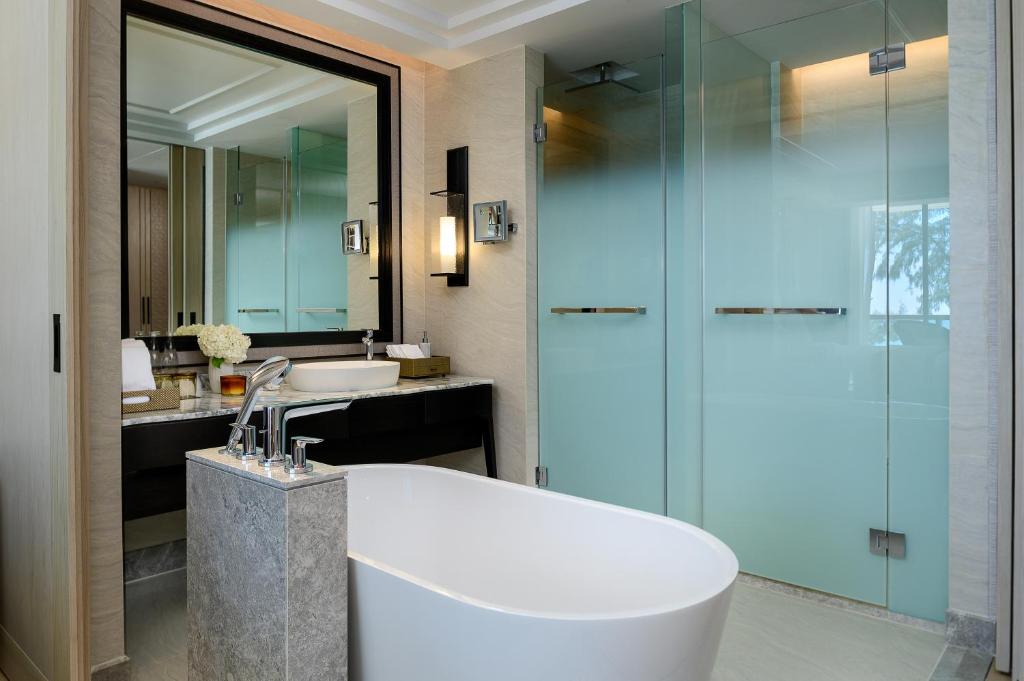a bathroom with a tub and a sink and a shower at InterContinental Phuket Resort by IHG in Kamala Beach