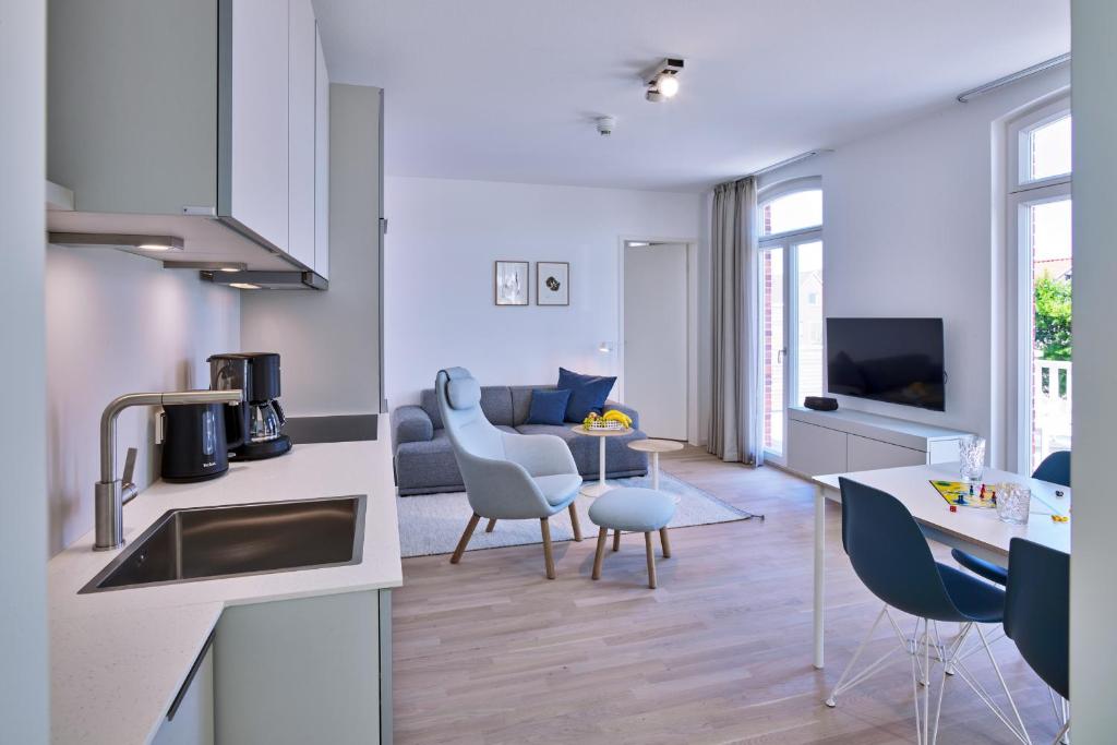 TV a/nebo společenská místnost v ubytování Lüttjeod Apartmentvilla Lüttjeod Apartmentvilla 08