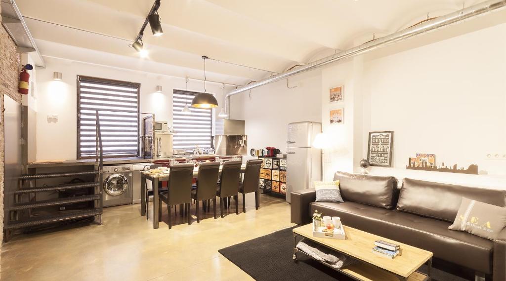a living room with a couch and a table at ApartsNouBcn Industria-Gracia in Barcelona