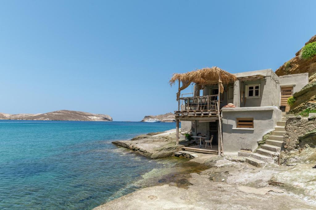 a house on the shore of a body of water at The Fishermans Experience Tinos in Platiá