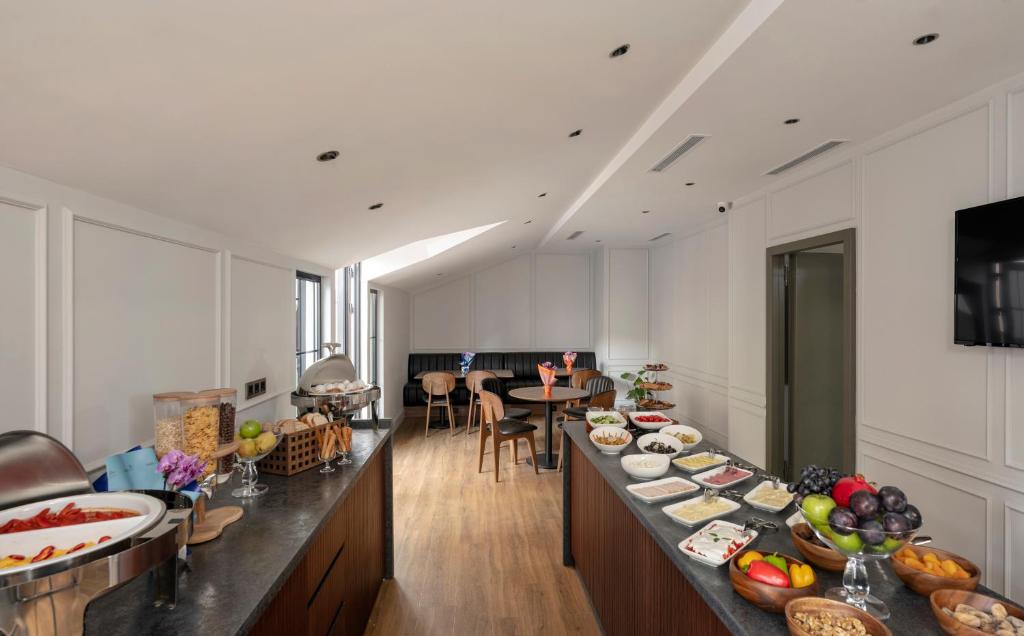 a kitchen with a long counter with food on it at Livro Hotel in Istanbul