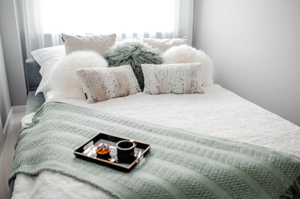 a bed with a tray of food on it at Apartament Staszica Nowa Sól in Nowa Sól