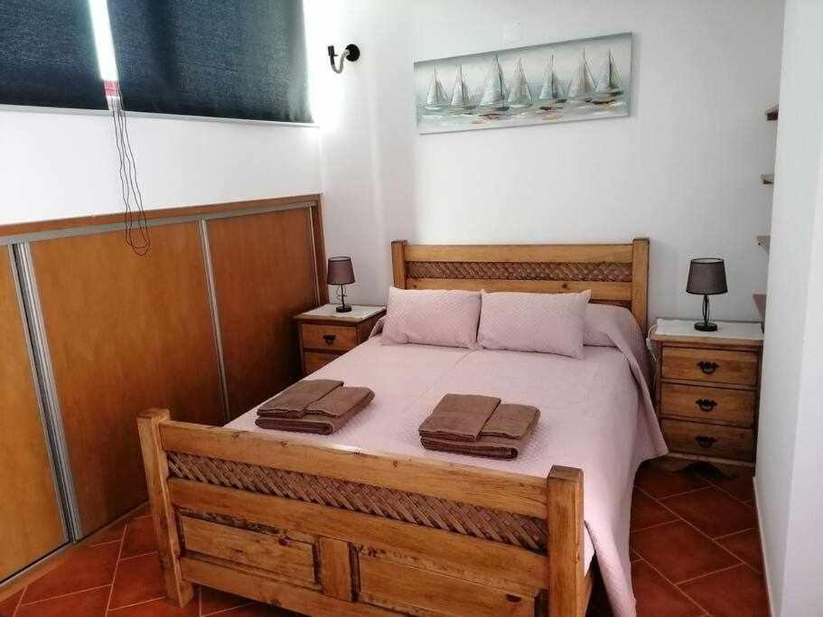 a bedroom with a bed with two towels on it at Di&Ana II - Alojamento Vila Viçosa in Vila Viçosa