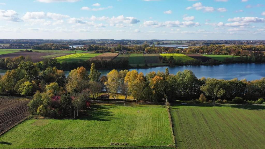 an aerial view of a field and a lake at Marina Złotowo in Złotowo