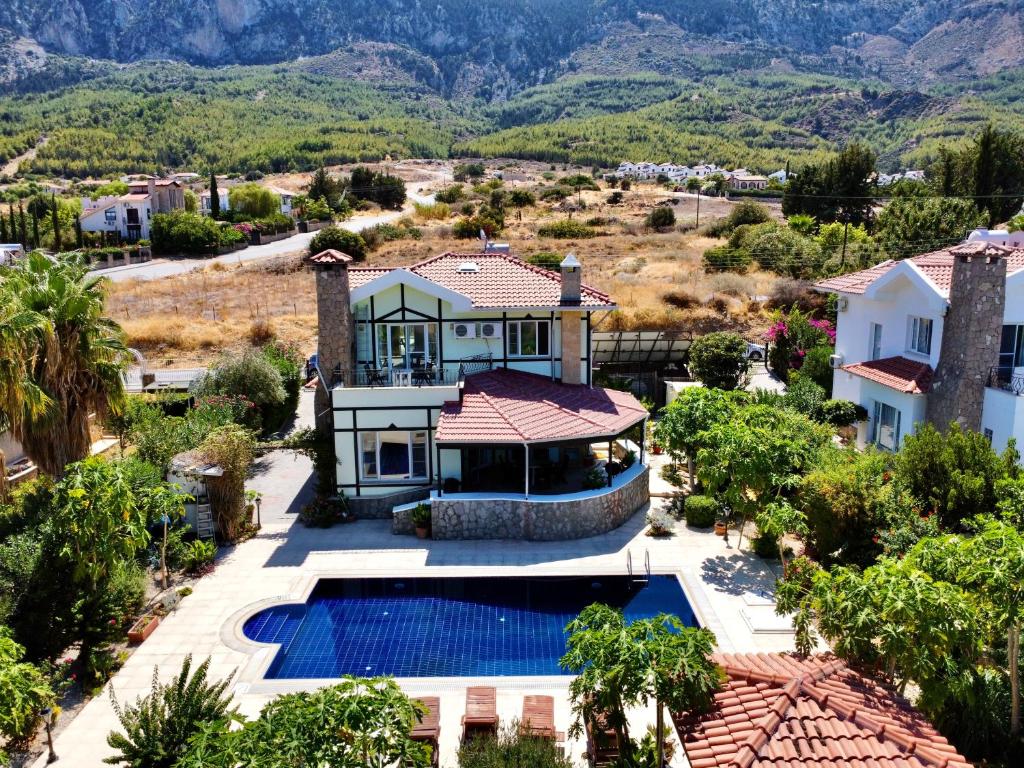 an aerial view of a house with a swimming pool at 4 Bedroom Deluxe Villa with Mountain and Sea View in Kérynia
