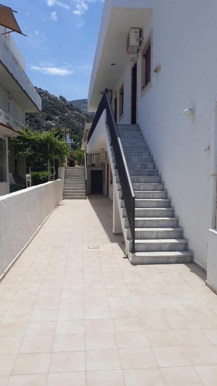 a stairway leading to a white building with stairs at Mary Apartments in Stalís