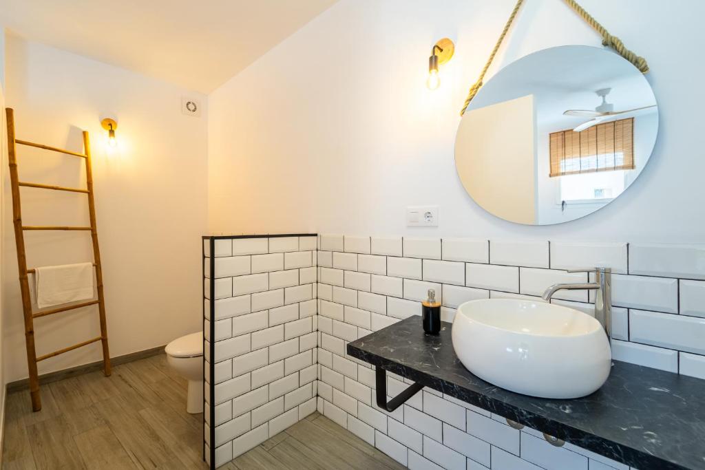 a bathroom with a sink and a mirror at Calas De Meca in Los Caños de Meca