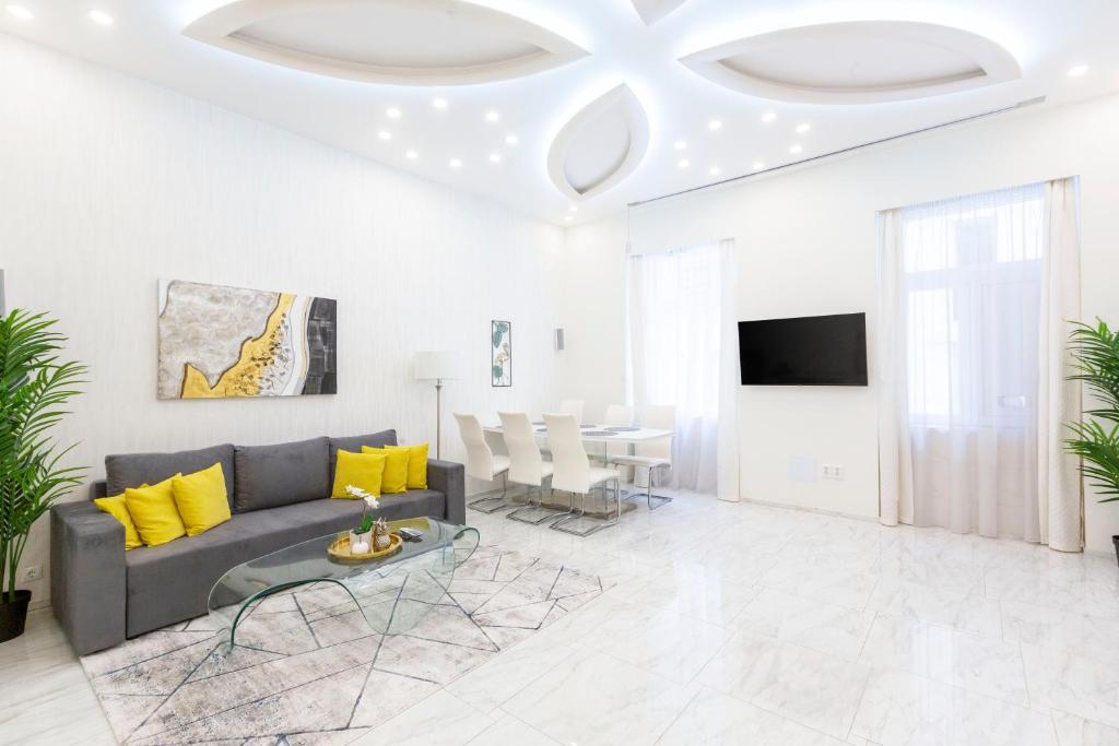a living room with a couch and a table at Luxurious Central Apartment next to the Danube River in Budapest