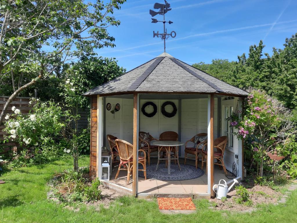 a gazebo with a table and chairs in a yard at Feriengut Bohn in Bernkastel-Kues