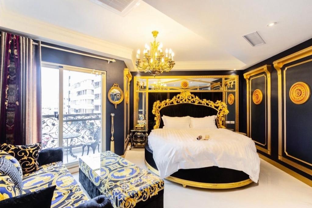 1 dormitorio con 1 cama extragrande y lámpara de araña en 艾菲爾精品民宿, en Hualien City