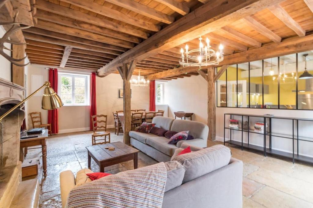 ein Wohnzimmer mit einem Sofa und einem Tisch in der Unterkunft La Garenne in Bretenière
