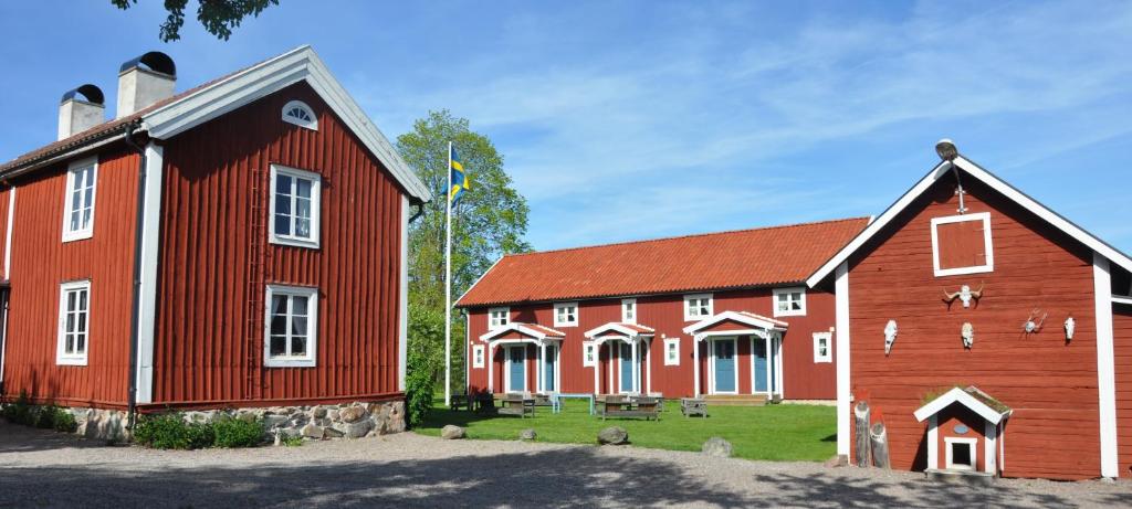 a red barn with a red and white building at Kröken in Kvillsfors