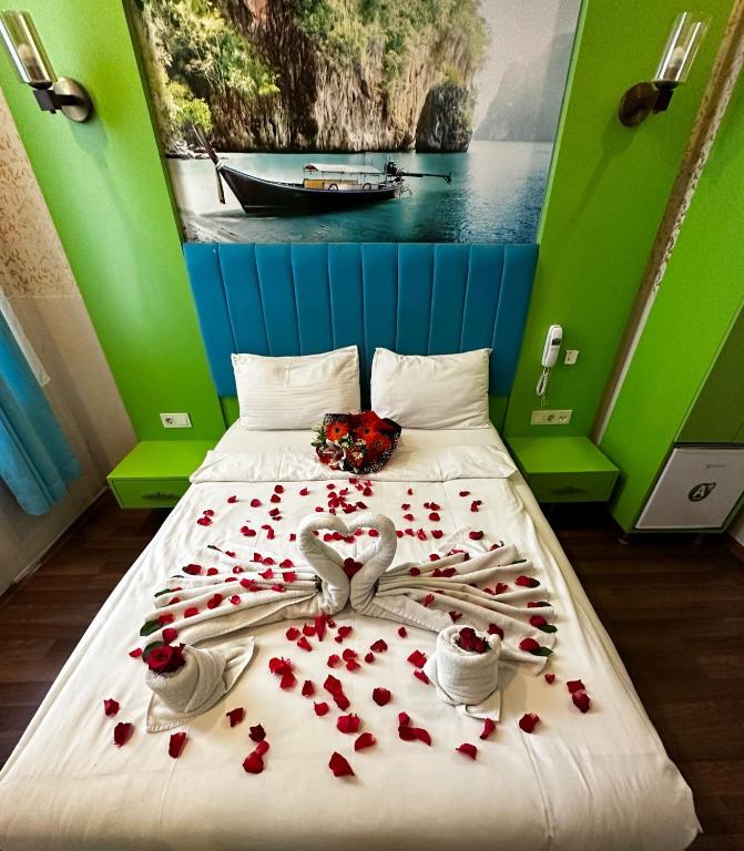 a bedroom with a bed covered in roses and hearts at Hotel Megaron in Istanbul