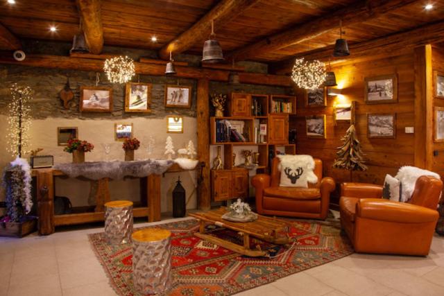 a living room filled with furniture and a fireplace at Chalet Faure in Sauze dʼOulx