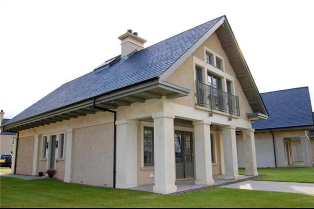 a large house with a blue roof at Lough Erne Fisherman's Cottage in Enniskillen