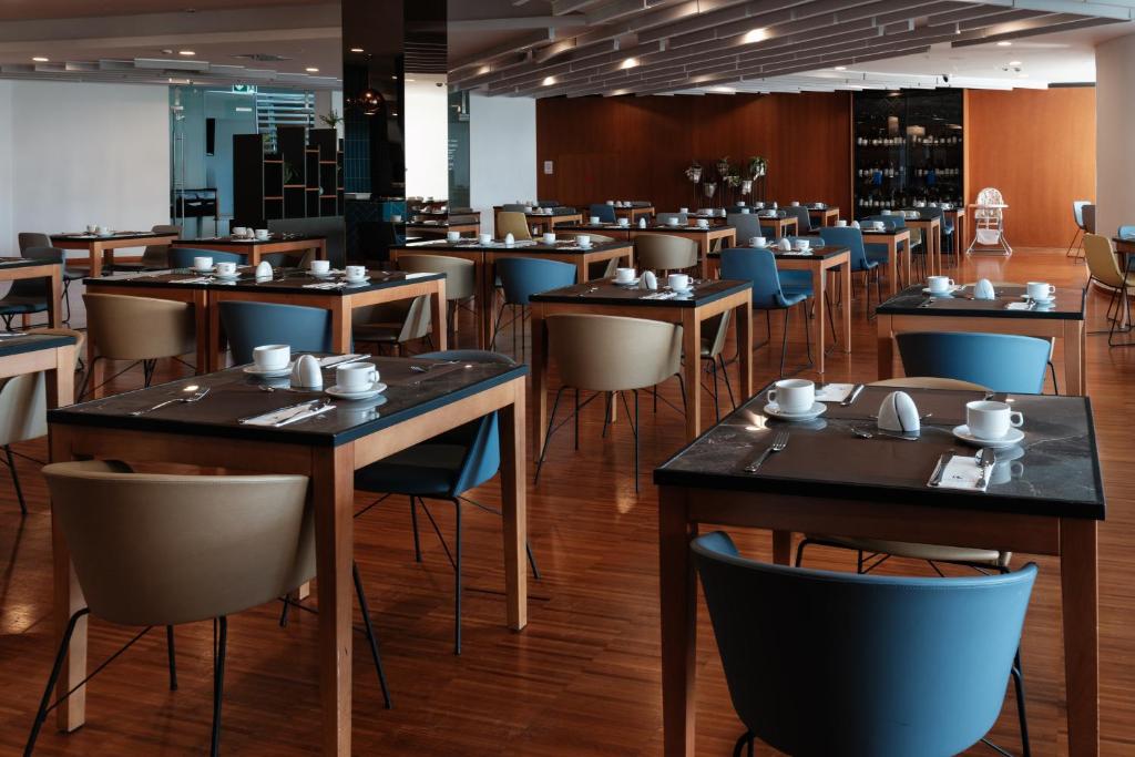 a dining room filled with tables and chairs at Eurostars Queen of Montenegro in Budva