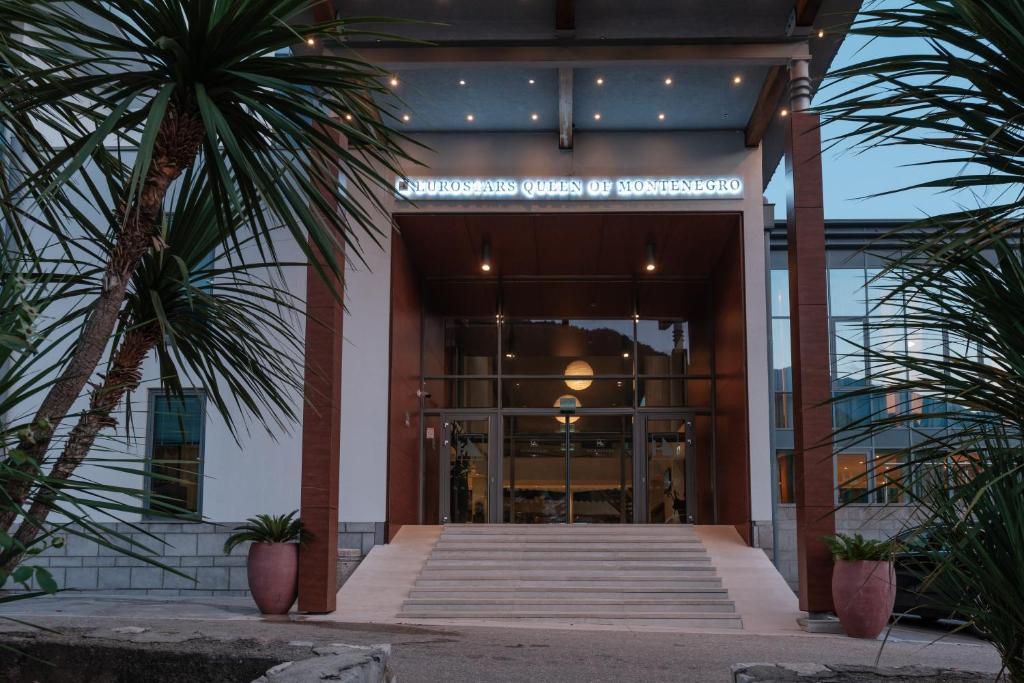 a entrance to a building with palm trees in front of it at Eurostars Queen of Montenegro in Budva