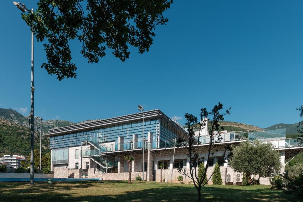 an office building with a tree in front of it at Eurostars Queen of Montenegro in Budva