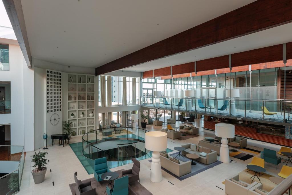 a large room with a lobby with chairs and tables at Eurostars Queen of Montenegro in Budva