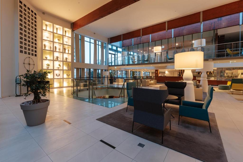a lobby with chairs and a table in a building at Eurostars Queen of Montenegro in Budva