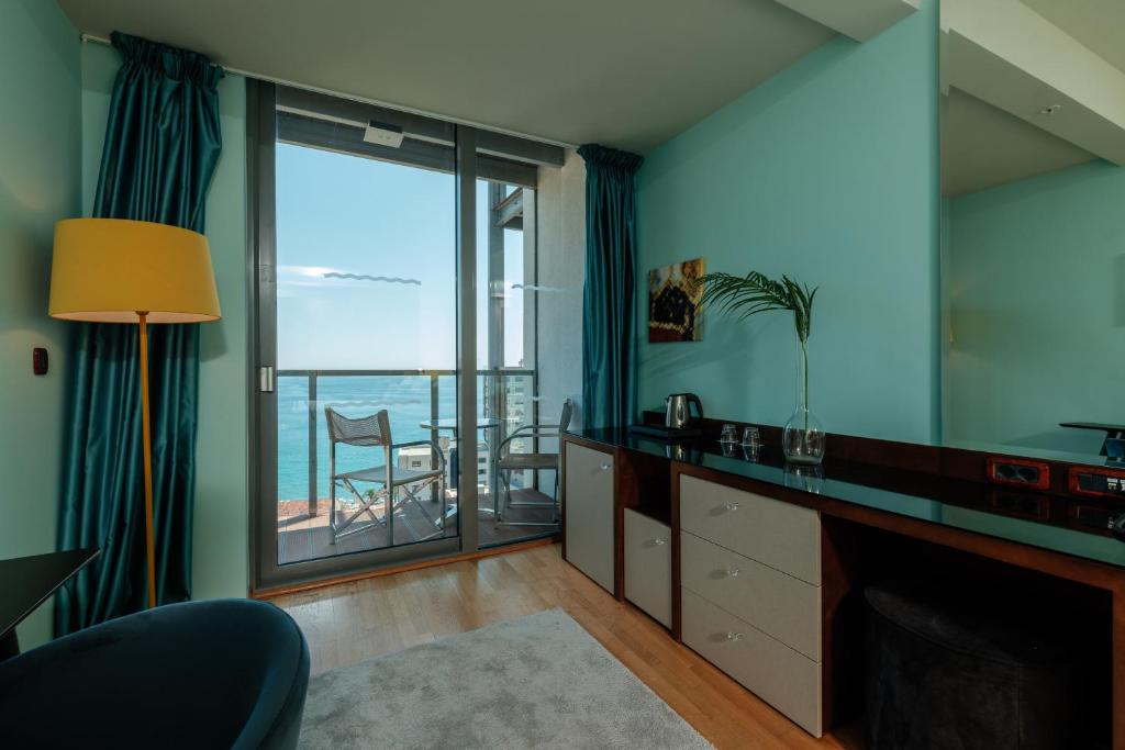 a living room with a view of the ocean at Eurostars Queen of Montenegro in Budva