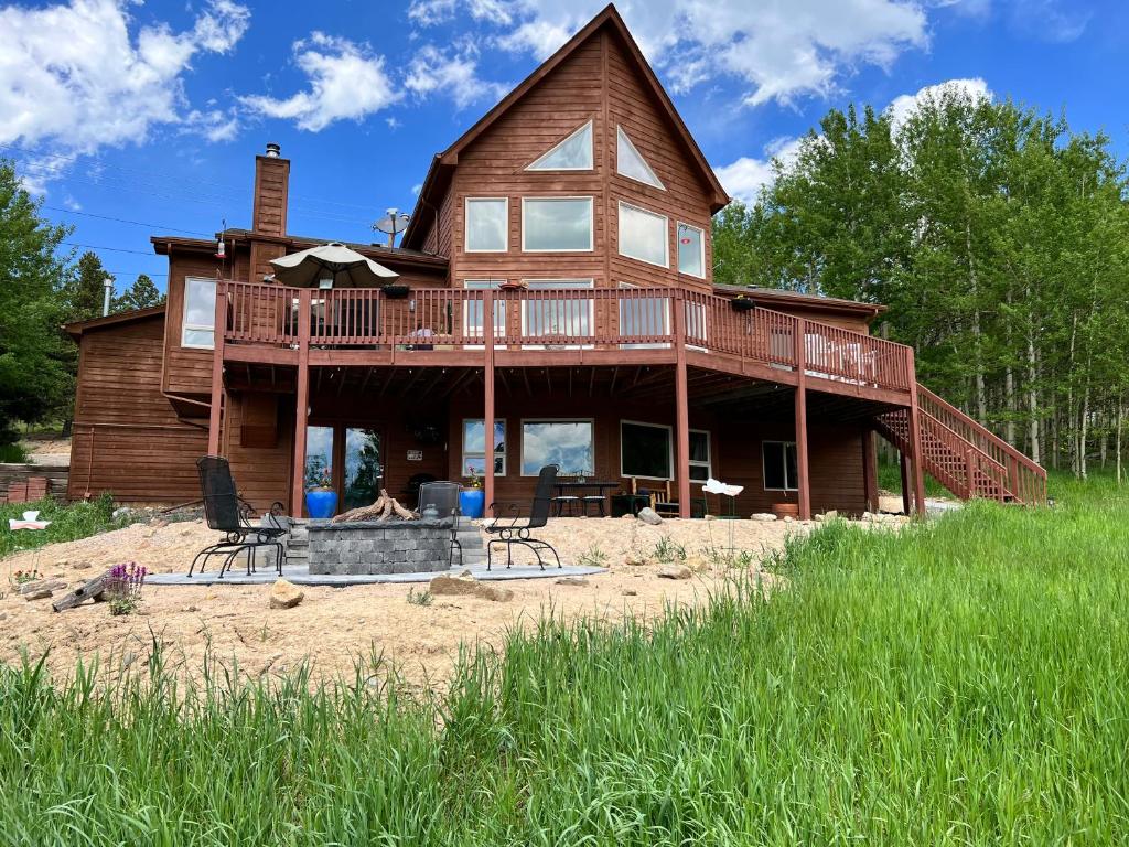 a large wooden house with a deck on the beach at Meandering Moose Apartment in Black Hawk