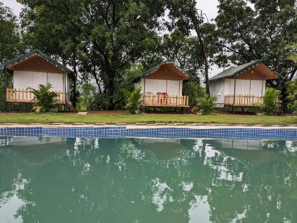 a couple of resorts with a pool of water at Panshet Camping in Welhe
