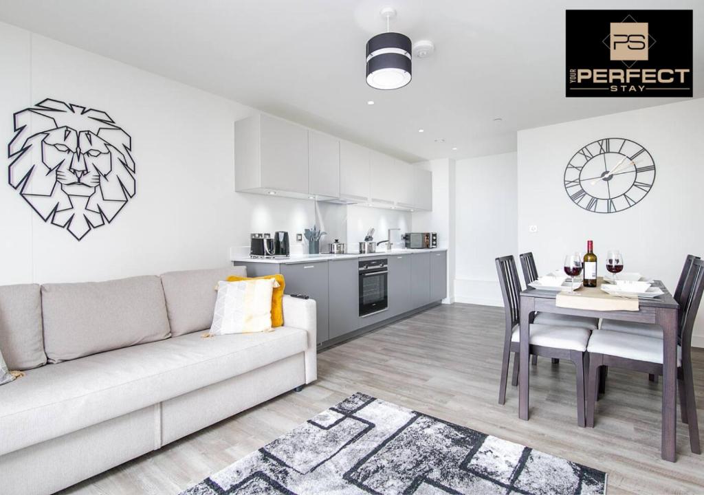 a living room with a couch and a table and a kitchen at Manhattan Apartment City Centre By Your Perfect Stay short lets Birmingham in Birmingham