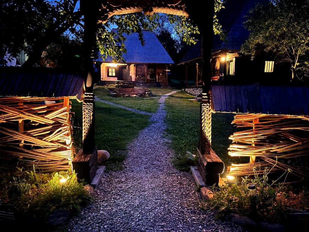 a pathway in front of a house at night at The Village Pension in Breb